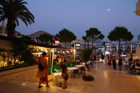 SARANDE, ALBANIA - JULY 7, 2025: People visit cafes and restaurants in downtown Sarande resort town in Southern Albania.のeditorial素材