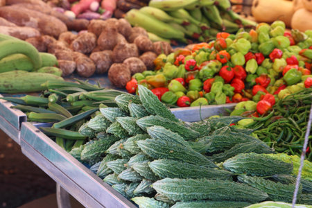 Mercato del Carmine local market in Catania city, Sicily, Italy. Exotic vegetables: bitter gourd, okra and habanero peppers.の写真素材