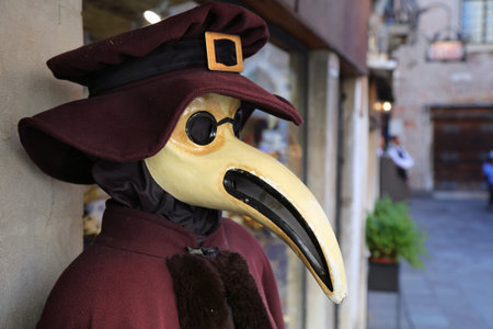 Historical plague doctor costume displayed in the street of Venice, Italy.の写真素材