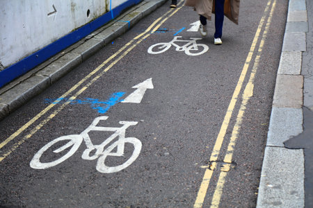 Pedestrian walking on a bicycle path in London, UK. Cycling route issue.