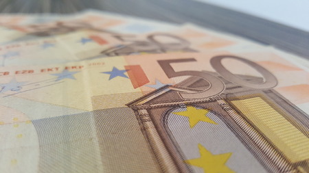 Banknotes stacked on each other in different positionsの写真素材