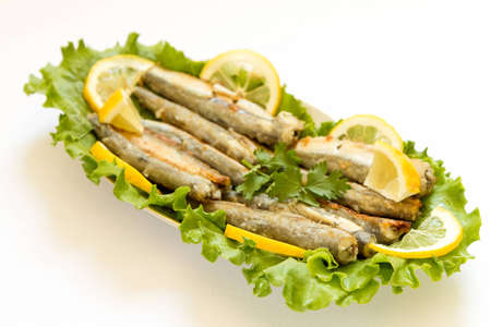 Grilled Capelin, on leaves of salad on a white backgroundの写真素材