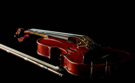 Old scratched violin isolated  on blackの写真素材