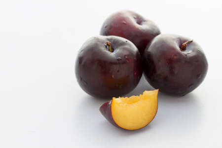 Black plums isolated
