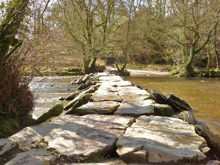 an ancient clapper bridge fording the River Barle, Exmoor, South West England.の写真素材