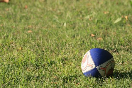 Rugby ball lying on the fieldの写真素材