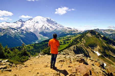 A man watching Mt Rainier from top of a Trailの写真素材