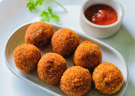 A tasty recipe of croquettes confection-ed with fish, onion, garlic, olive oil, milk, lemon, pepper and salt, wrapped in beaten egg and breadcrumbs, fried in hot oil.の写真素材