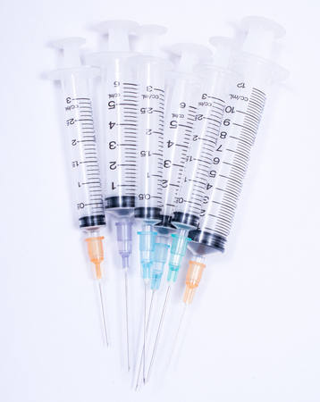 Syringe with droplet and medical on white background.