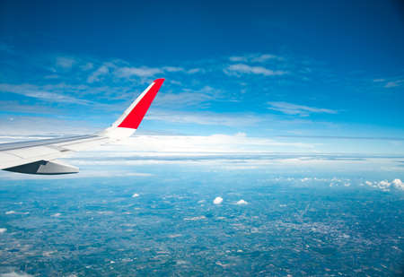 Looking through window aircraft during flight in wing with a nice blue sky.の写真素材