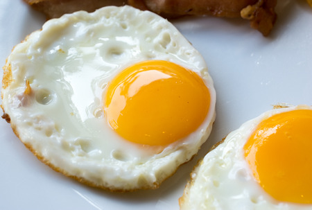 fried eggs on a white plateの写真素材