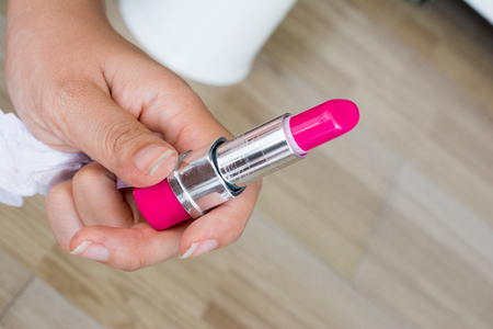 Pink lipstick on wood tableの写真素材
