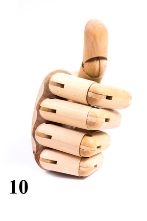 Sing of number ten from wooden hand isolated on white backgroundの写真素材