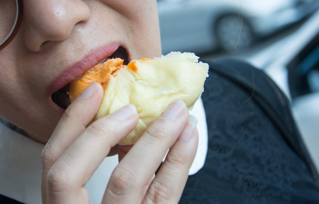 Steamed dumpling or chinese bun thai tea on the hand going to eatの写真素材