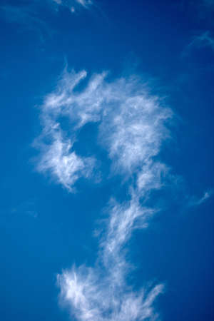 Strange cloud, alike question simbol in skyの写真素材