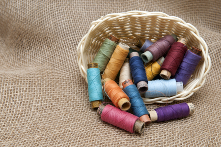 Handicraft supplies in basket on burlap backgroundの写真素材