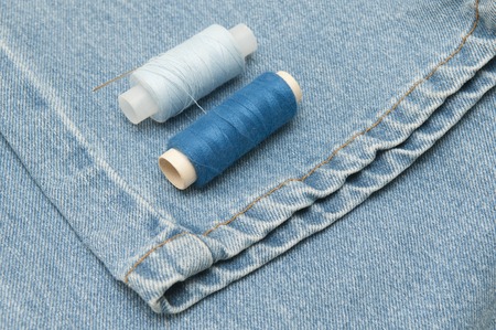 Sewing supplies and old clothes for repair. Photo
