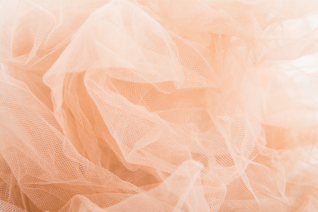 Lightweight fabric mesh lace on textured wooden table, texture of the fabric is beautifully draped backgroundの写真素材