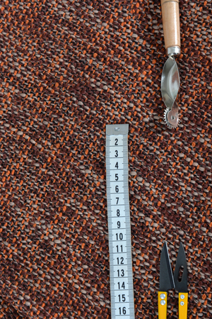 Sewing tools and sewing supplies accessories sewing on the brown fabric background with place for your textの写真素材