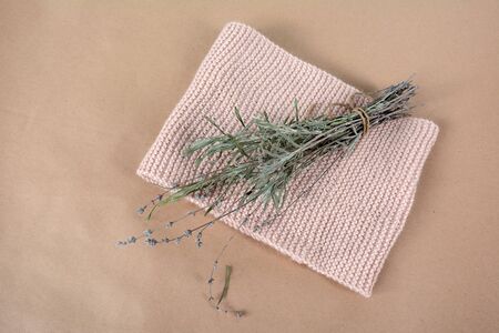 Knitted biege scarf and a bunch of lavender.. Still-life handmade