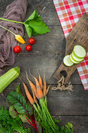 Fresh vegetables with leaves and flower on the old wooden table. Country styleの写真素材