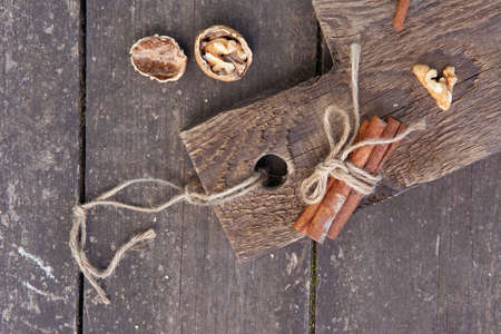 Cinnamon sticks and walnut on a wooden board, photo rustic styleの写真素材