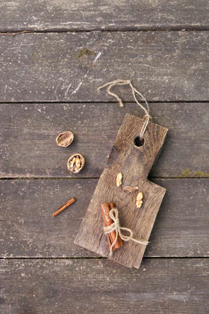 Cinnamon sticks and walnut on a wooden board, photo rustic styleの写真素材