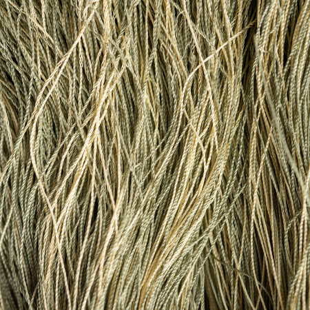 Texture of synthetic golden threads. Background sewing, hobby.