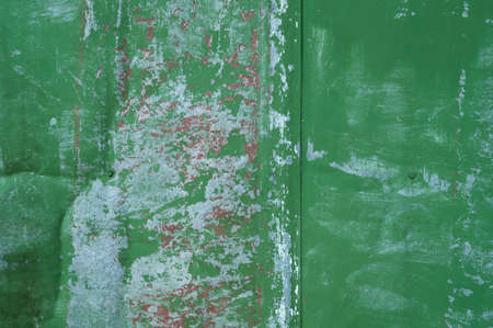 Painted green surface of old metal peeling paint background.の写真素材