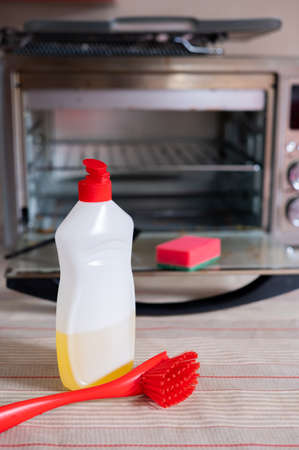 Dirty oven electric oven and items for washing and cleaning detergent sponge brush.の写真素材