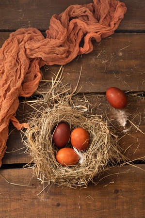 Painted Easter chicken eggs in a nest. Holiday Easter concept background. Copy spaceの写真素材