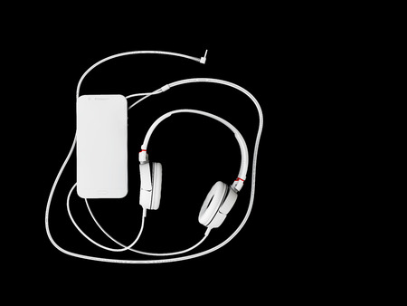 3d illustration of top view of headphones and phone on black backgroundの写真素材