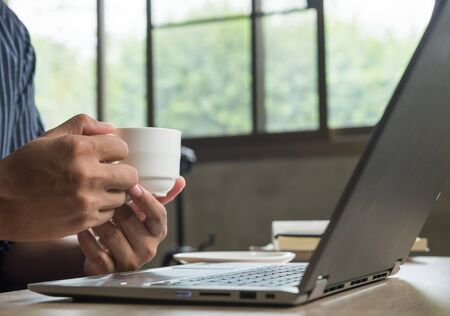 Businessman working with laptop and a cup of coffeeの写真素材
