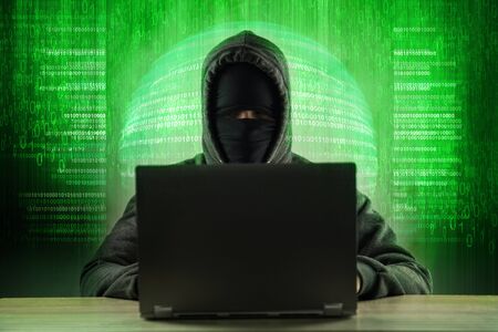 Hacker using laptop. Hacking the Internet server.