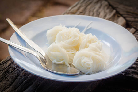 thai noodles on a plate and eating utensilsの写真素材