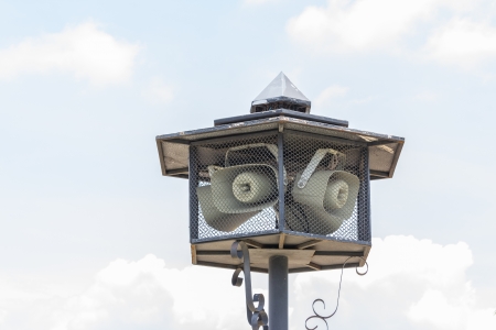 Outdoor public address loudspeakers against a blue skyの写真素材