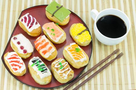 eating sushi doughnut with black coffee for breakfast or appetizersの写真素材