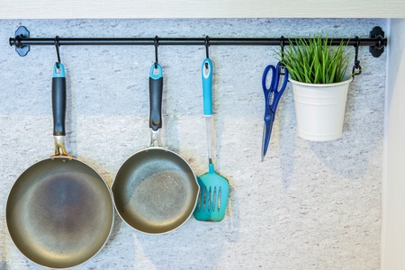 kitchen equipment hanging on the wallの写真素材