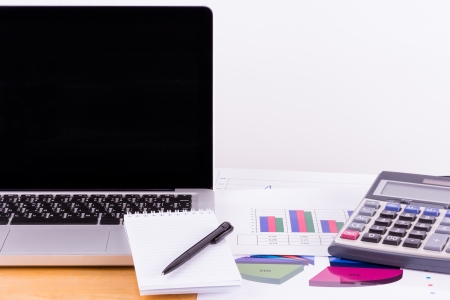 blank notepad and laptop on the tableの写真素材