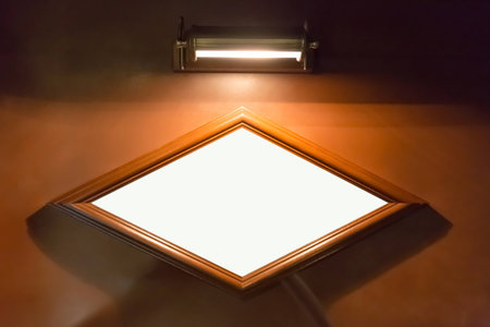 Blank diamond-shaped quadrangle billboard on wall with lightingの写真素材