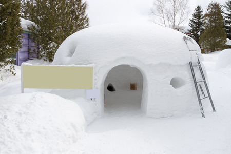 snow shelter with blank yellow signの写真素材