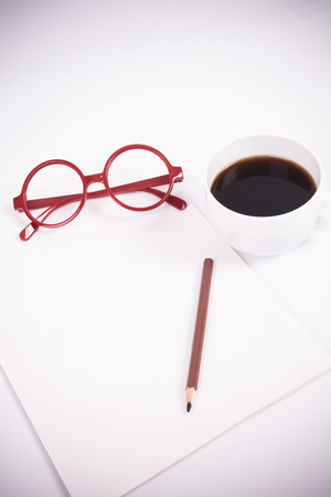 blank paper with coffee, glasses (soft color and vignette filtered)の写真素材