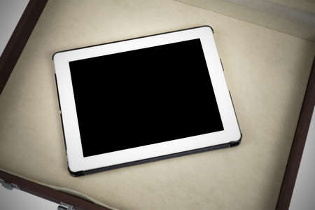 Modern white tablet pc in briefcase isolated on white (vignette filtered process)