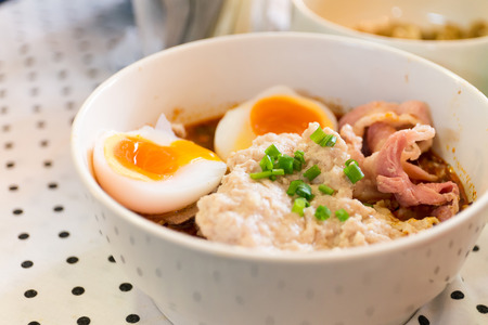Thai noodle with pork and boiled egg on tableの写真素材