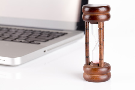 hourglass with laptop - time concept