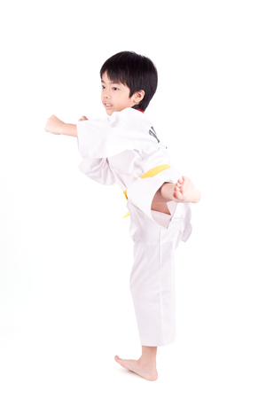 little boy in a Taekwondo suit isolated on white backgroundの写真素材