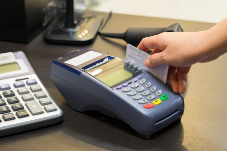 Hand Swiping Credit Card In Store