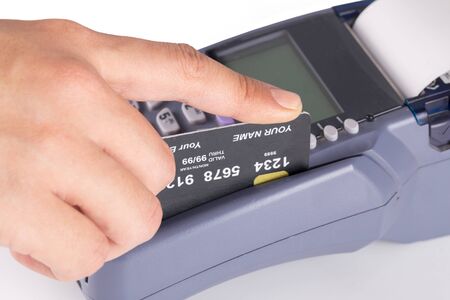 Hand Swiping Credit Card on White