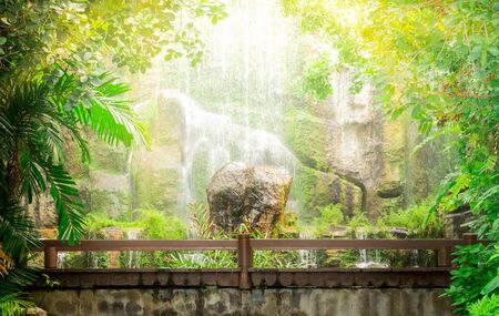 Wooden Bridge With Beautiful Waterfall In Backgroundの写真素材