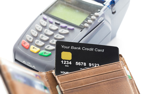 Credit Card in Wallet with Credit Card Machine in Backgroundの写真素材